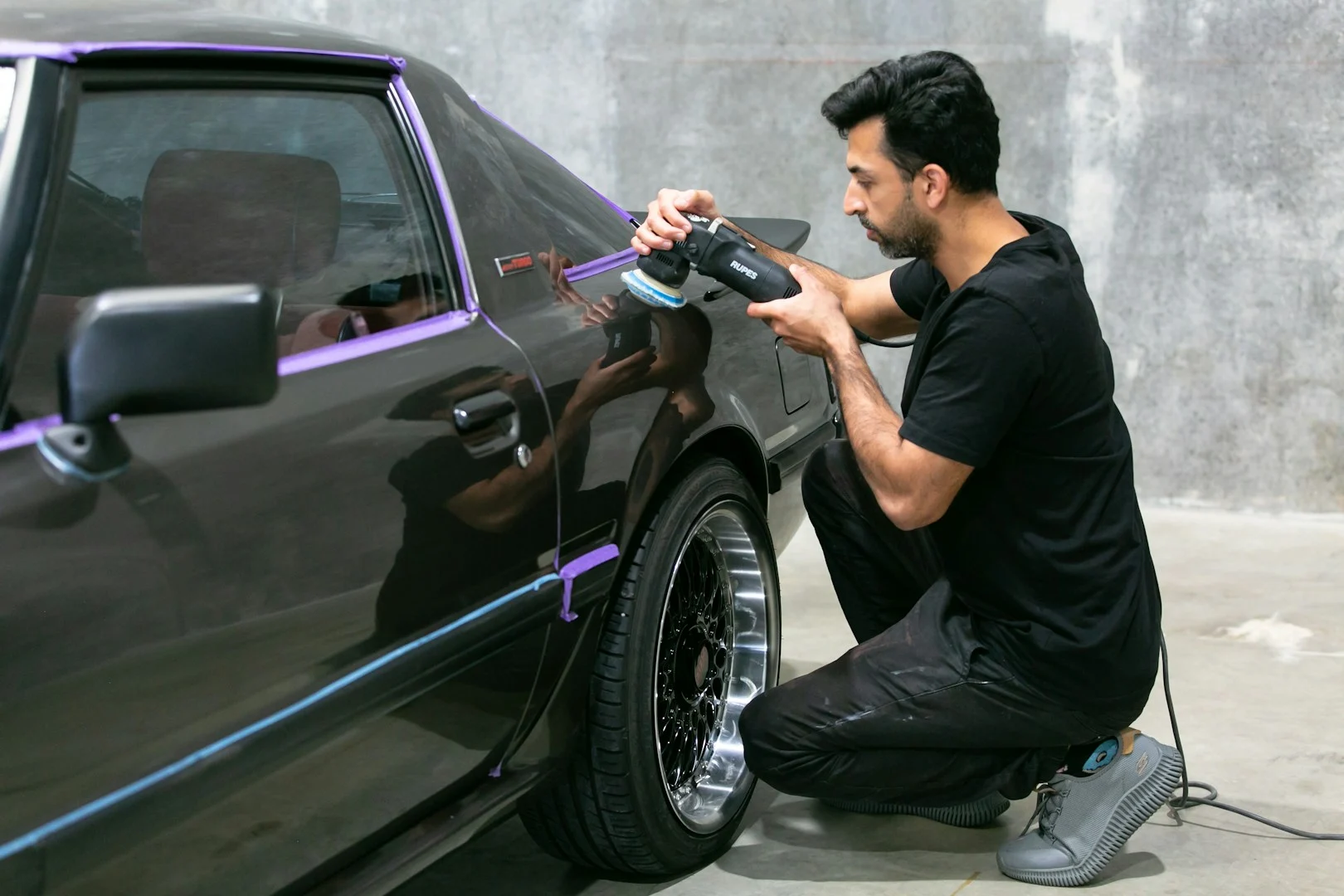Automotive technician refinishing a vehicle