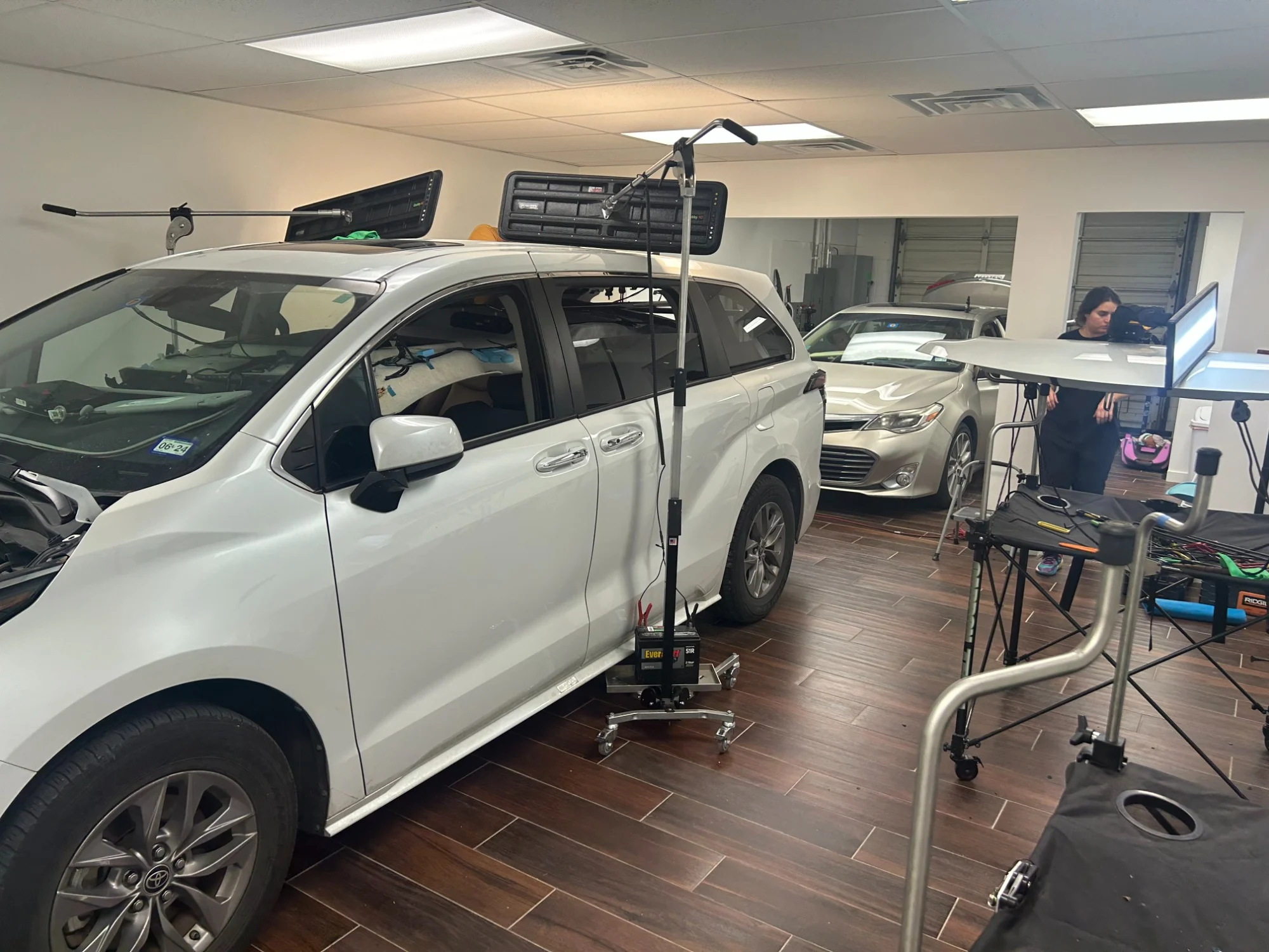 Vehicles positioned for advanced calibration work inside the DriveUp shop